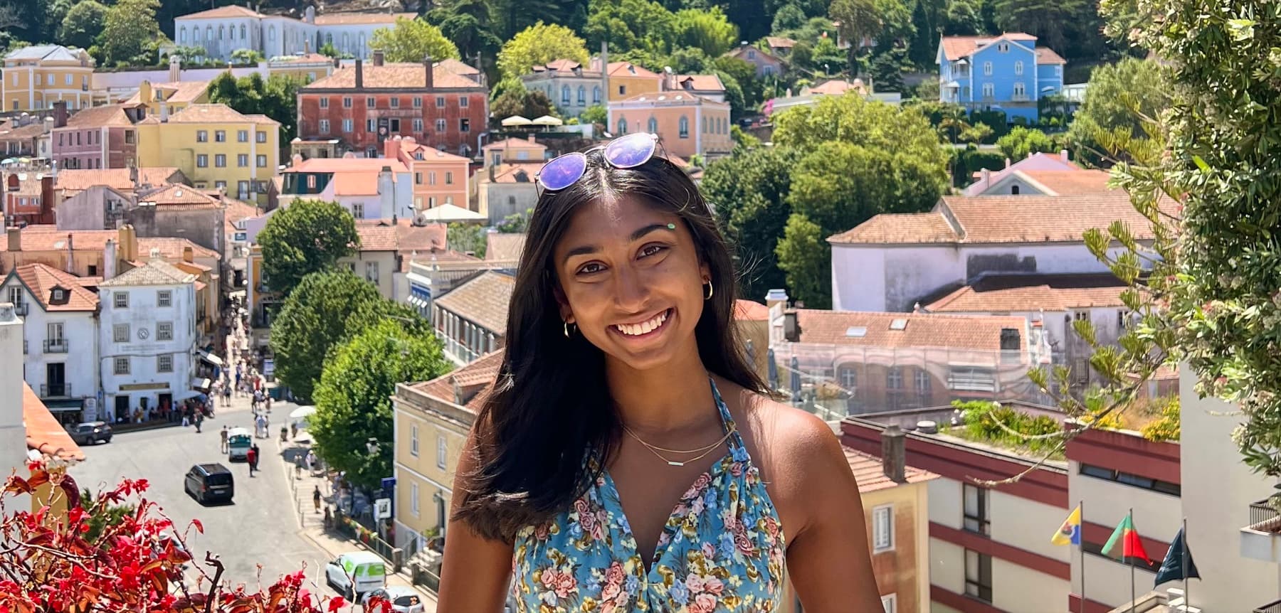 Angelie standing in front of a hillside town.