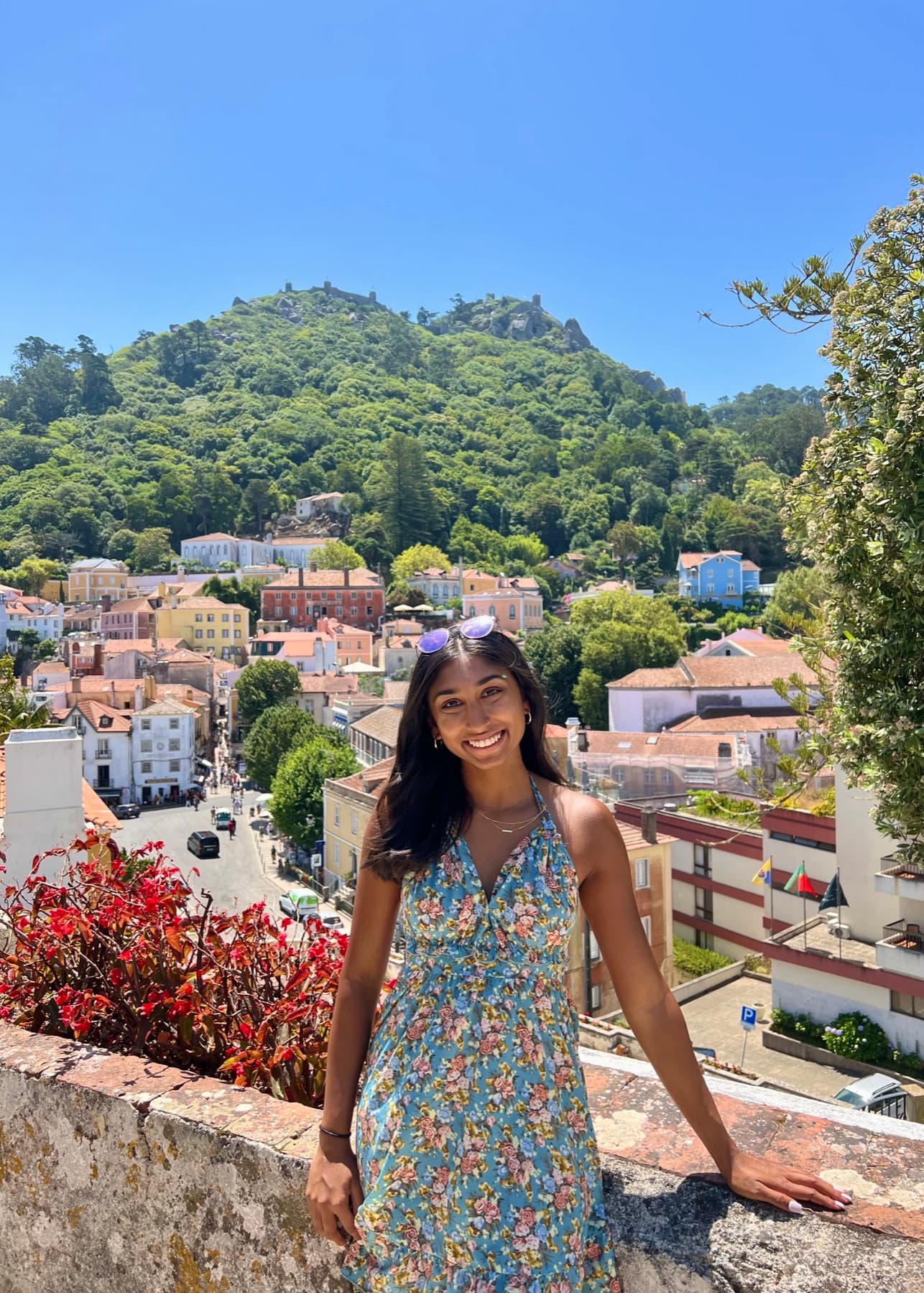 Angelie standing in front of a hillside town.